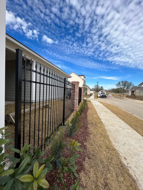 Black ornamental steel fence at a Baton Rouge residential property.