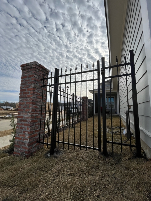 Black aluminum fence enclosing a residential backyard in Baton Rouge, Louisiana